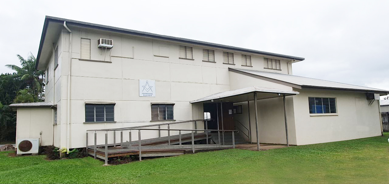Exterior of Bentley Park Freemasons Lodge, cream building with Square and Compasses sign and access ramp